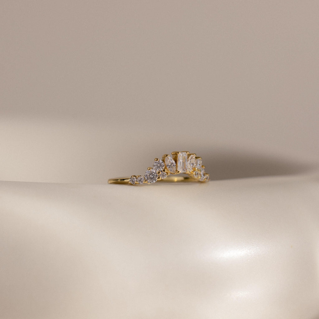 The Diamond Curve Cluster Ring is shown on a smooth, off-white surface with a neutral background.