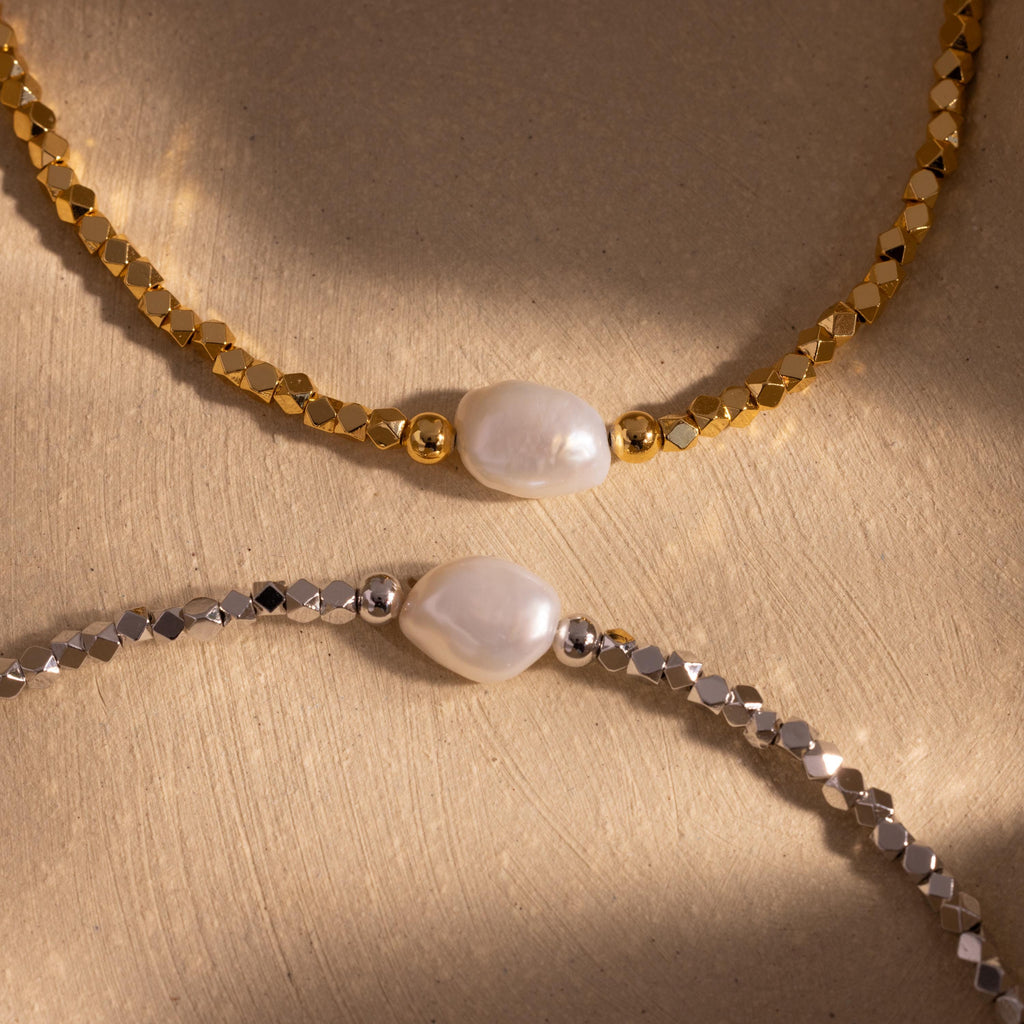 Beaded Pearl Bracelets in gold and silver, each featuring faceted metallic beads with a single natural white pearl centerpiece, displayed together on a neutral background for an elegant contrast.