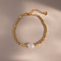 Beaded Pearl Bracelet in gold featuring faceted metallic beads with a single natural white pearl centerpiece, displayed on a neutral background with delicate lighting for an elegant presentation.