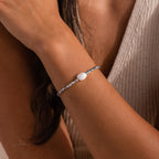 Beaded Pearl Bracelet with faceted silver beads and a single natural white pearl centerpiece, styled on the wrist for a modern and elegant look.