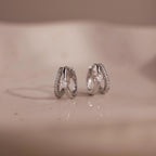 Pave Diamond Duo Huggies in Sterling Silver featuring small star-shaped accents and pave-set stones, displayed on a neutral surface.