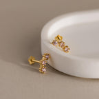 Birthstone Cluster Flatback Studs featuring gold and small pink gemstones, perfect for stacking or wearing as delicate birthstone earrings, displayed on a round white dish.