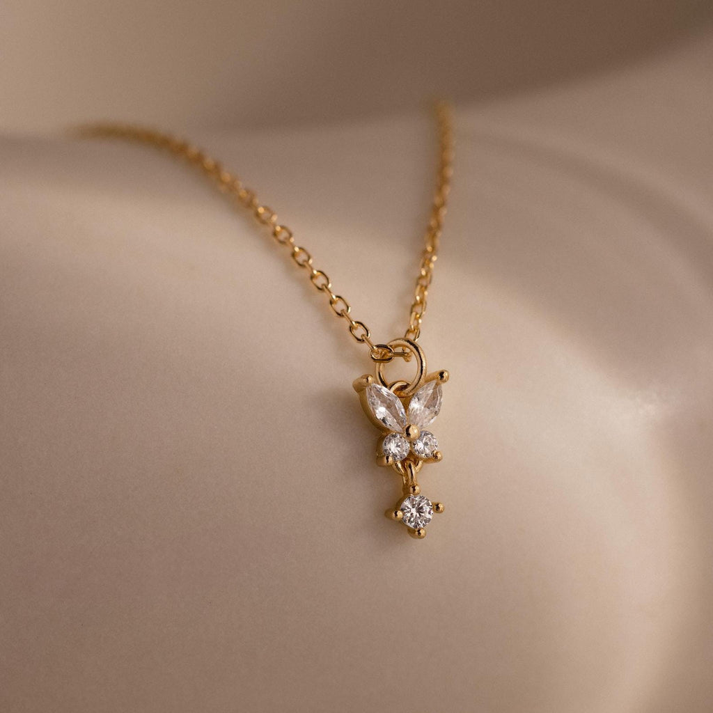 The Diamond Butterfly Drop Jewelry Set in 18K Gold features a delicate butterfly pendant with sparkling stones—an elegant choice for bridesmaids or as a thoughtful gift.