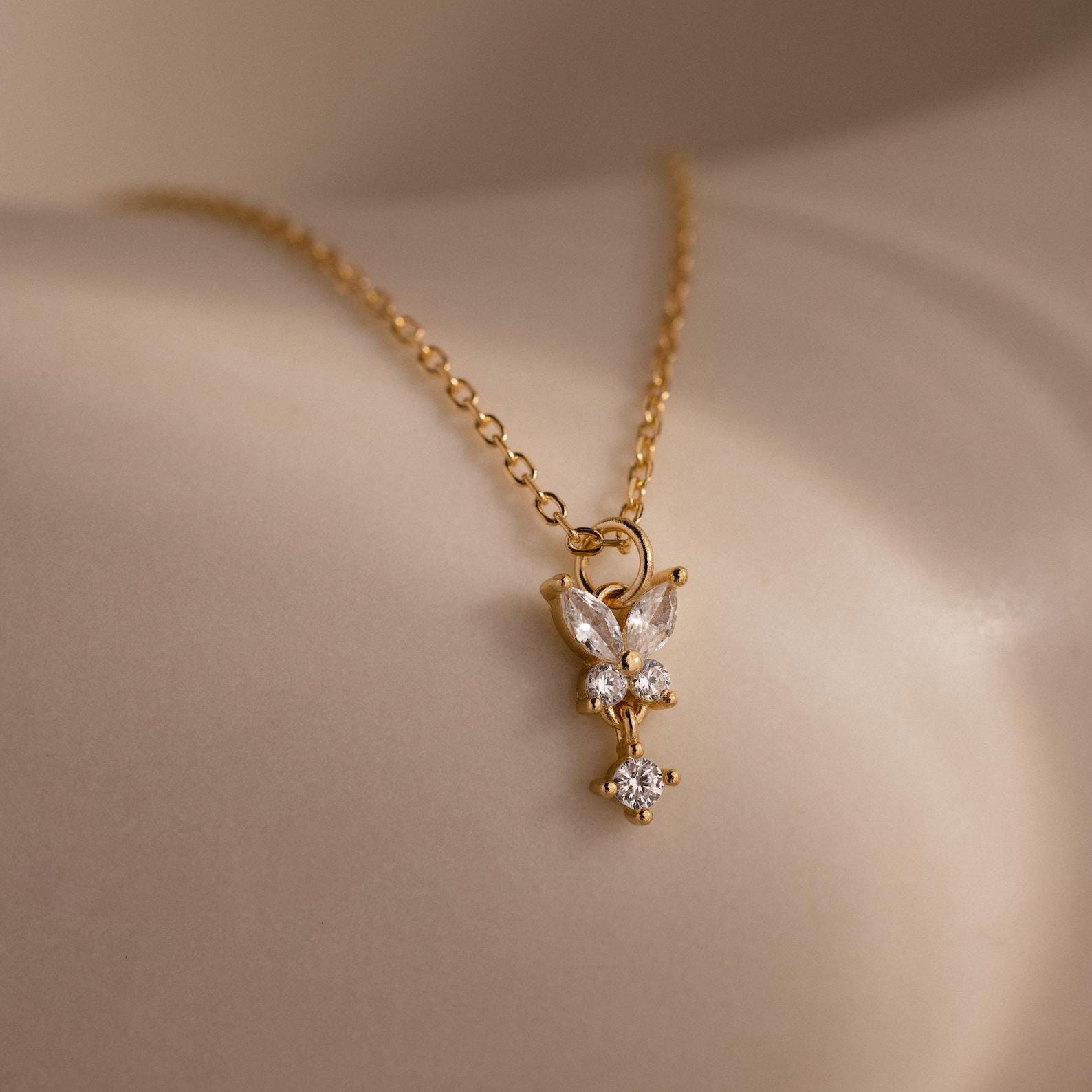 The Diamond Butterfly Drop Jewelry Set in 18K Gold features a delicate butterfly pendant with sparkling stones—an elegant choice for bridesmaids or as a thoughtful gift.