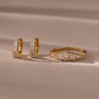 Art Deco Diamond Earrings & Ring Set in 18K Gold, featuring rectangular and round clear stones inspired by vintage jewelry, displayed on a beige surface.