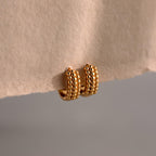 Beaded Chunky Hoops showcased on beige paper with a neutral background, these earrings combine classic hoop style and modern flair.