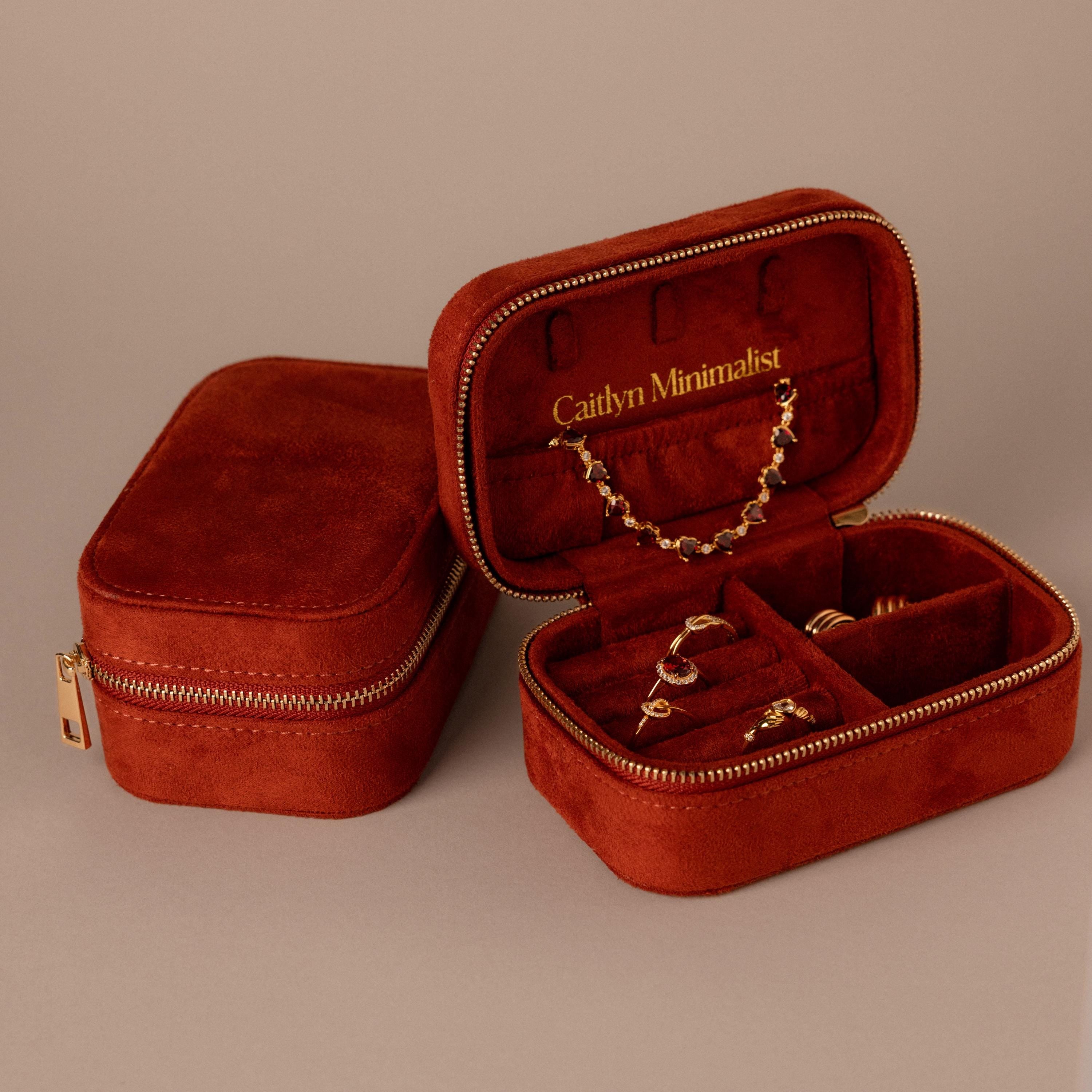 Two Cherry Red Velvet Jewelry Cases—one open to showcase gold jewelry, the other closed—ideal for luxury jewelry storage and elegant display.
