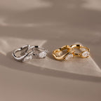 Flatlay of 2 pairs of our Hammered Diamond Teardrop Hoops in Silver and Gold