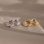 Flatlay of 2 pairs of our Hammered Diamond Teardrop Hoops in Silver and Gold