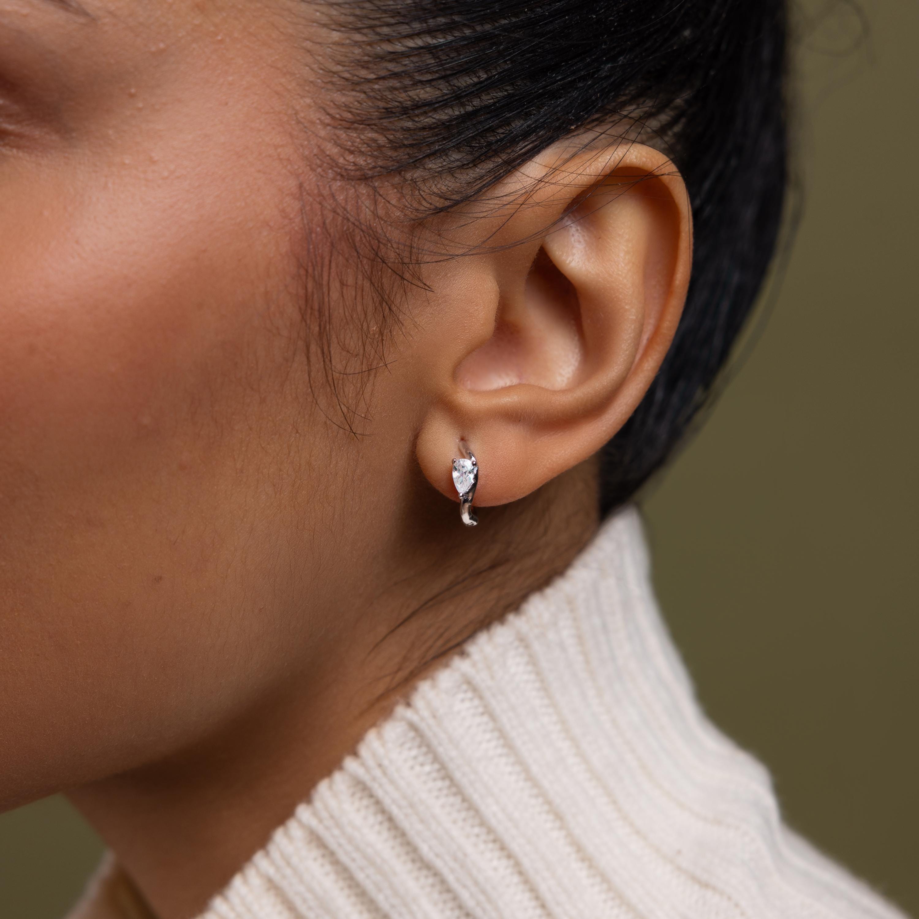 Close up of model wearing our Hammered Diamond Teardrop Hoops in Silver