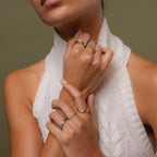 Model wearing our Mixed Metal Wave Ring Set, styled with our Duo Form Ring, Minimalist Ring and Diamond Bezel Tennis Ring