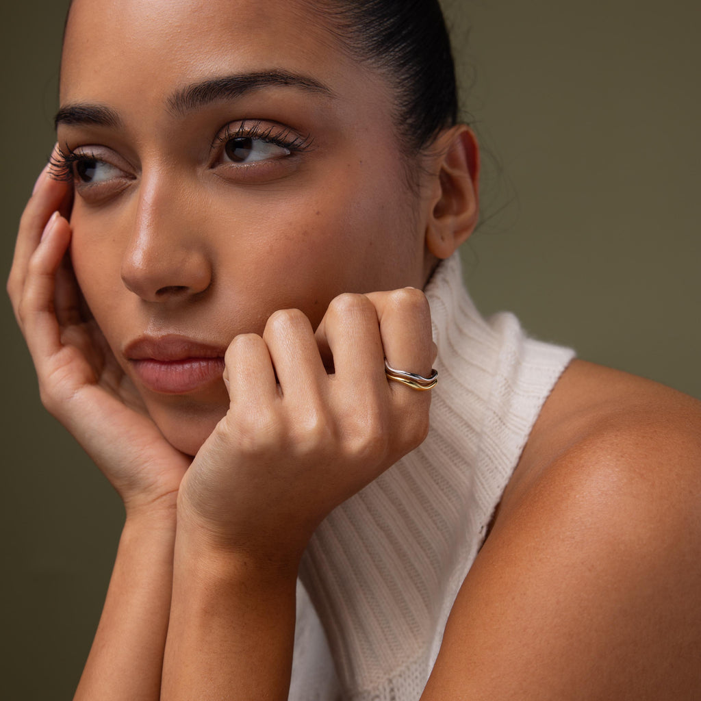 Model wearing our Mixed Metal Wave Ring Set
