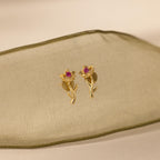 Flatlay of our Birth Flower Stud Earrings with Ruby stones