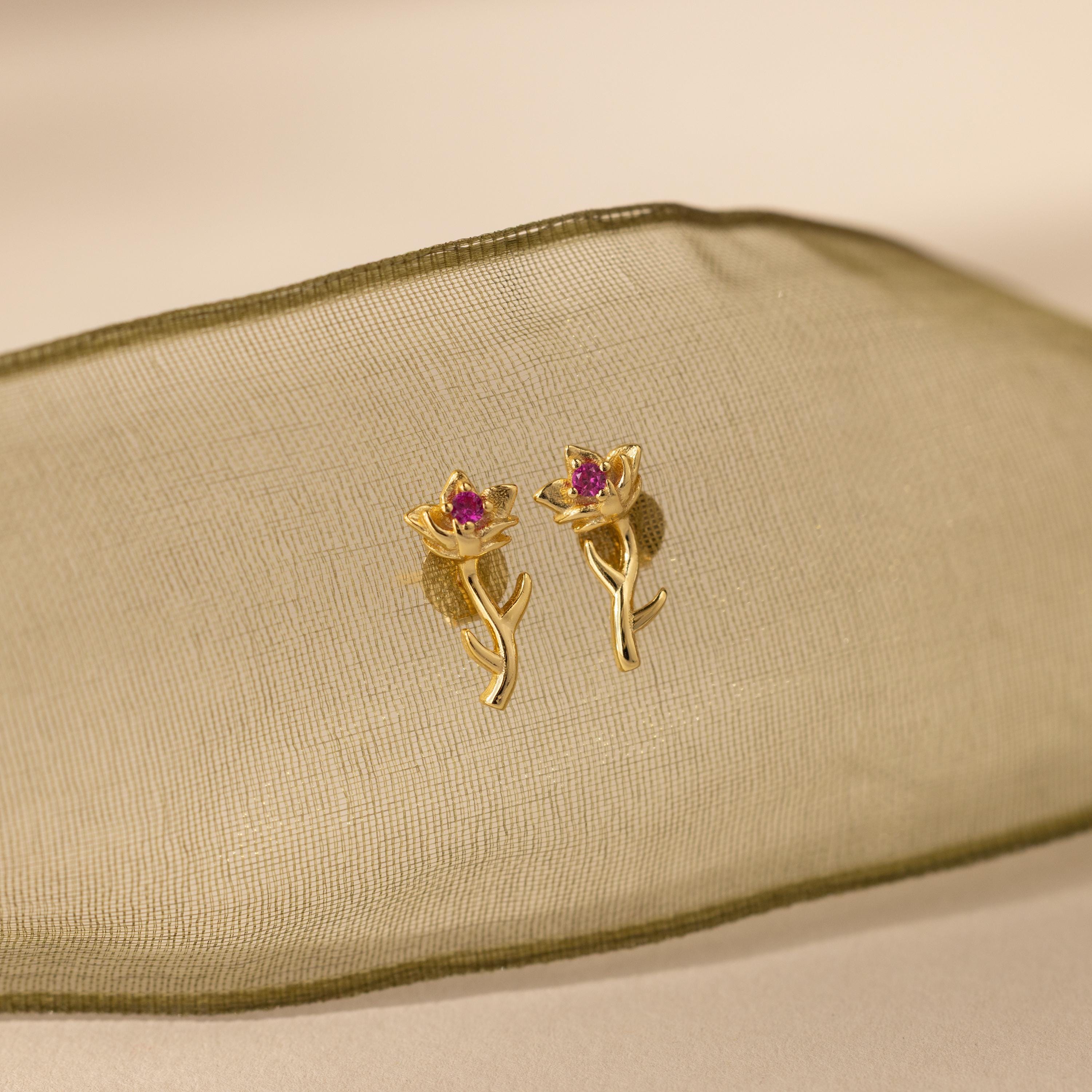 Flatlay of our Birth Flower Stud Earrings with Ruby stones