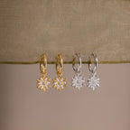 Flatlay of our Diamond Poinsettia Hoops in Silver and Gold