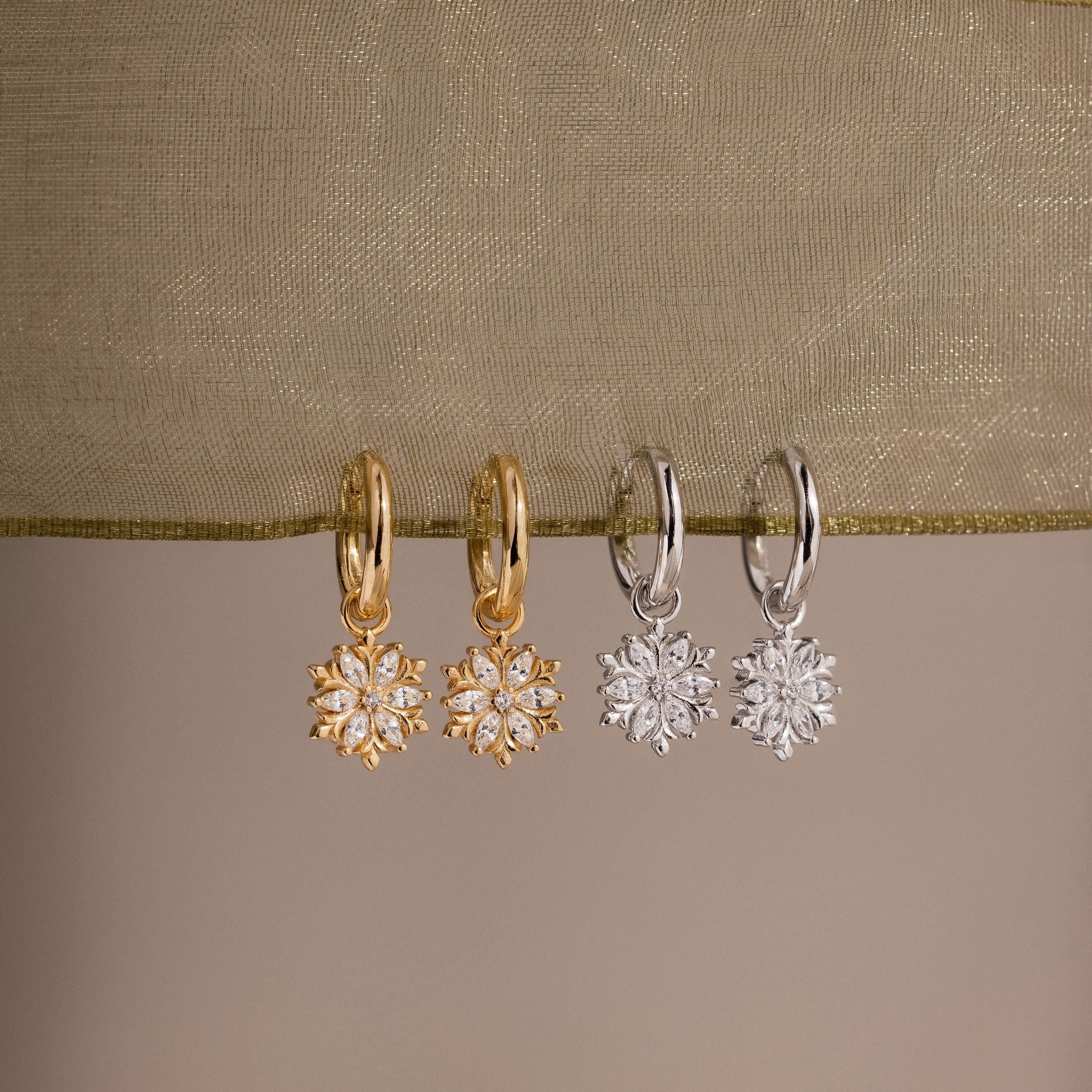 Flatlay of our Diamond Poinsettia Hoops in Silver and Gold