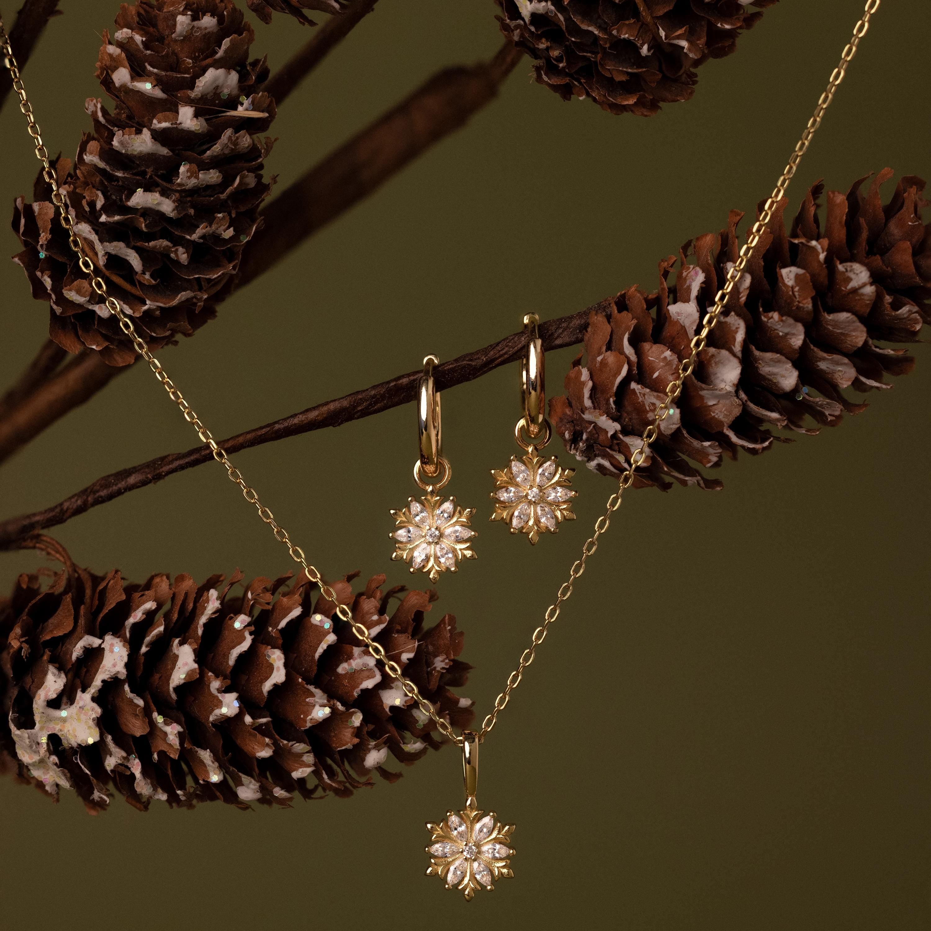Flatlay of our Diamond Poinsettia Hoops paired with our Diamond Poinsettia Necklace
