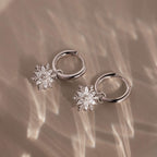 Flatlay of our Diamond Poinsettia Hoops in Silver