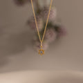 Flatlay of our Diamond Snowflake Necklace in Gold finish