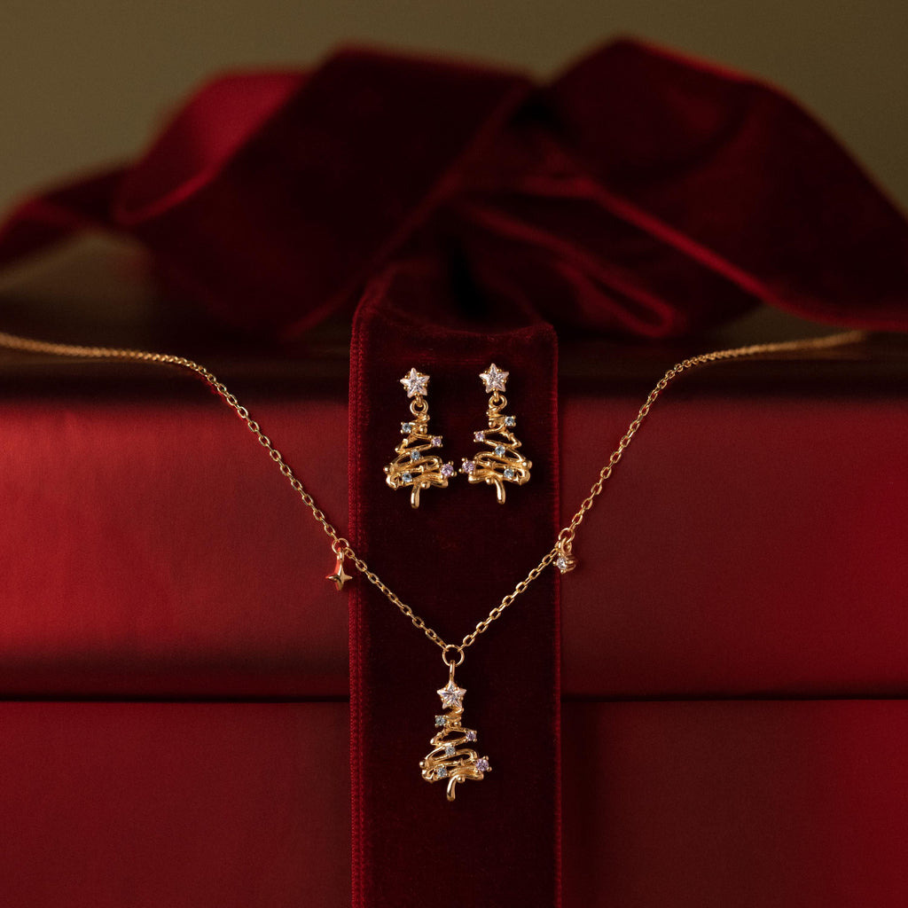 Flatlay of our Holiday Diamond Tree Necklace & Hoops Jewelry Set against a red velvet box