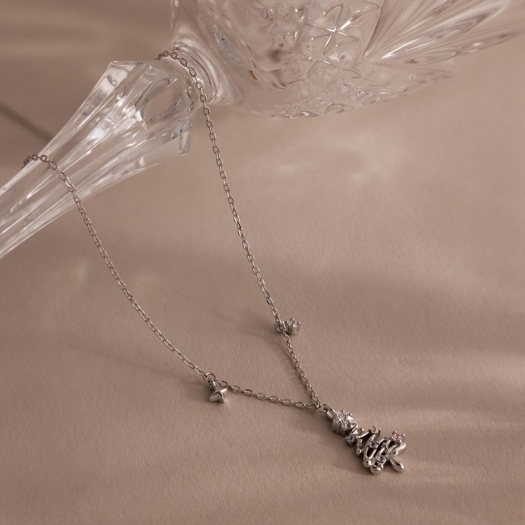 Flatlay of our Holiday Diamond Tree Necklace in Silver
