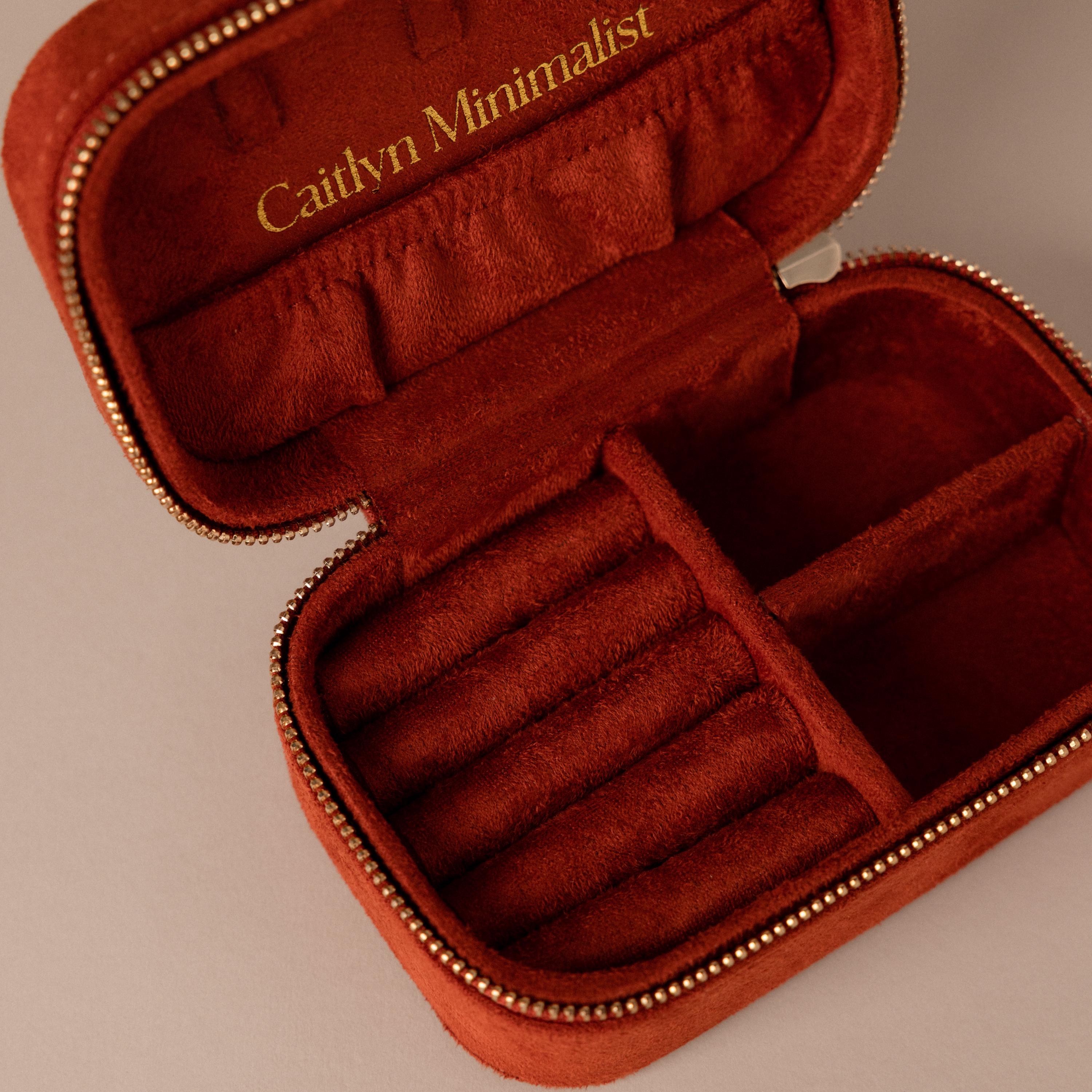 Open Cherry Red Velvet Jewelry Case with compartments, gold zipper, and "Caitlyn Minimalist" inscribed inside the lid.