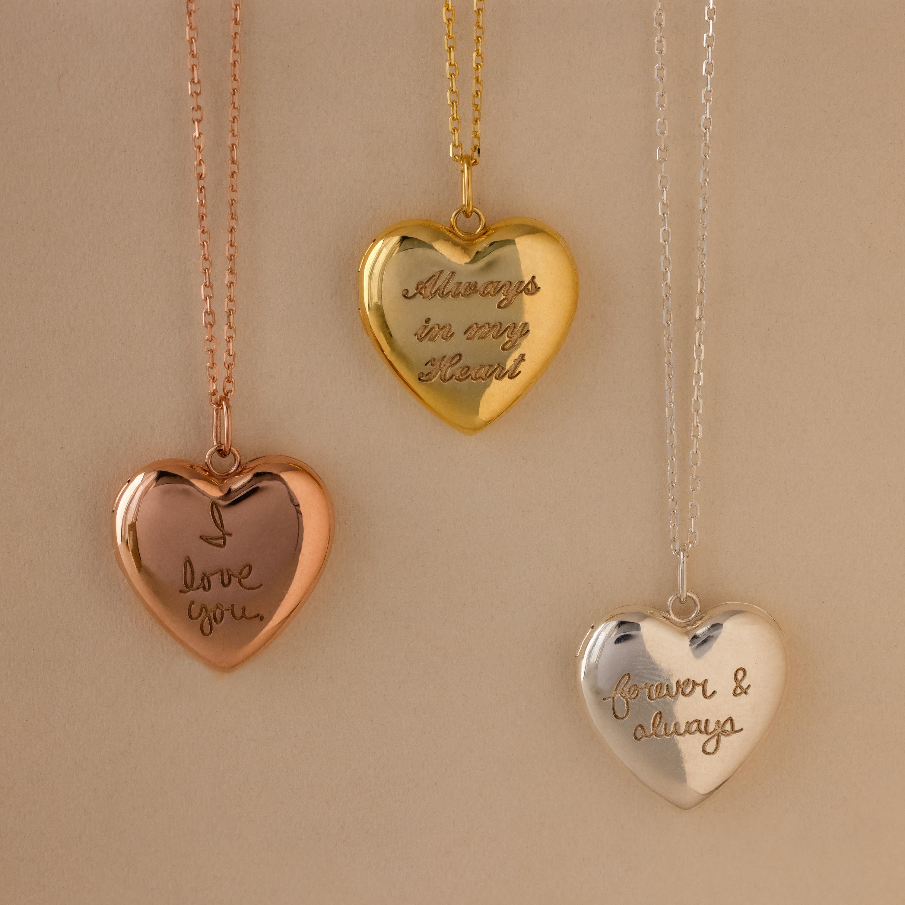 Close up flatlay of our Handwriting Heart Locket Necklaces in Rose Gold, Gold and Silver