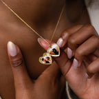 Close up photo of a model showcasing the inside of our Engraved Heart Locket Necklace in 18K Gold