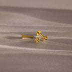 Flatlay showing our Tiny Bow Flatback Studs in 18K Gold with the flatback posts separated