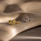Flatlay of 2 pairs of our Tiny Bow Flatback Studs in Gold and Silver