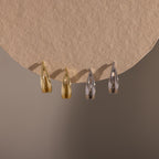 Flatlay of our Oval Duo Hoops in Gold and Silver