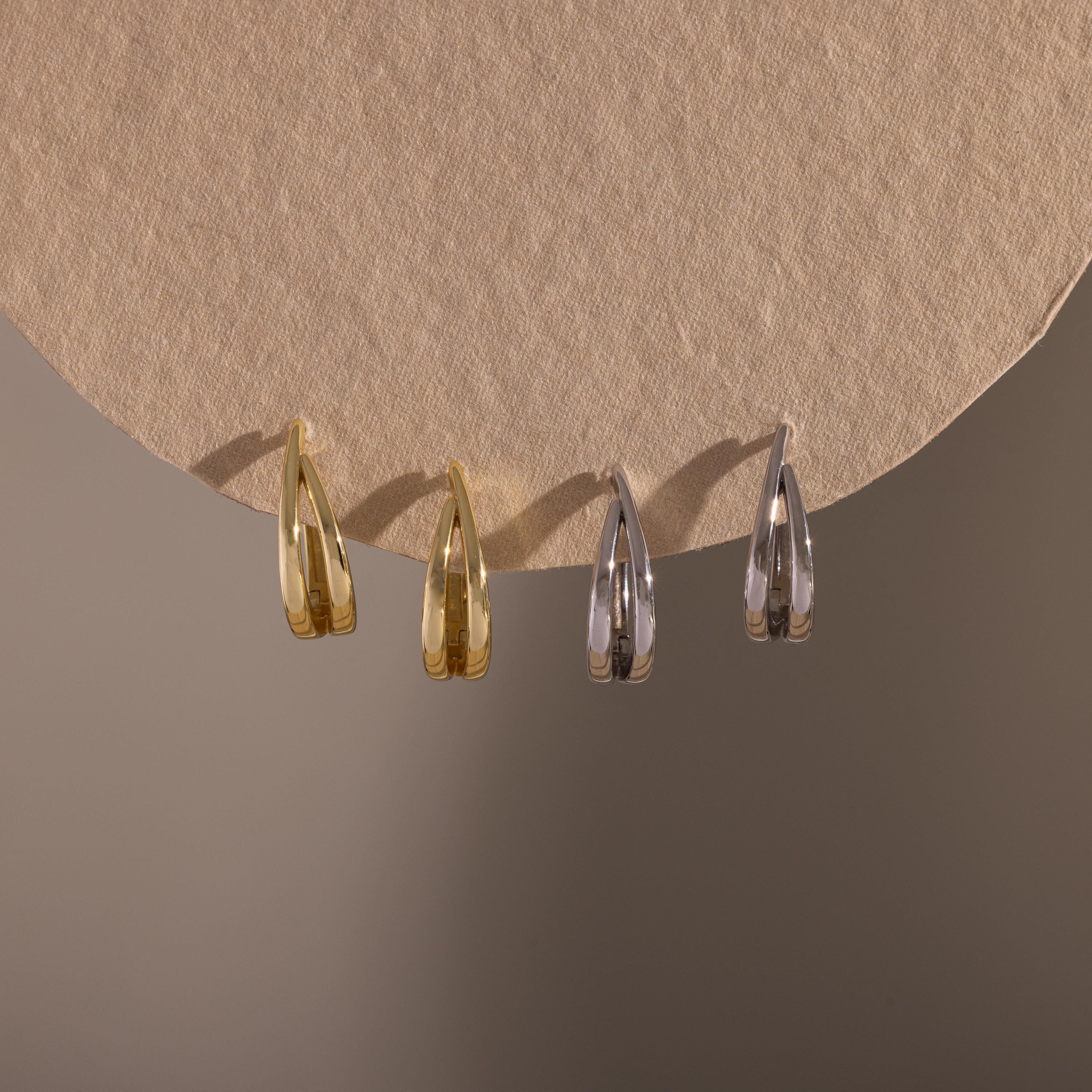 Flatlay of our Oval Duo Hoops in Gold and Silver