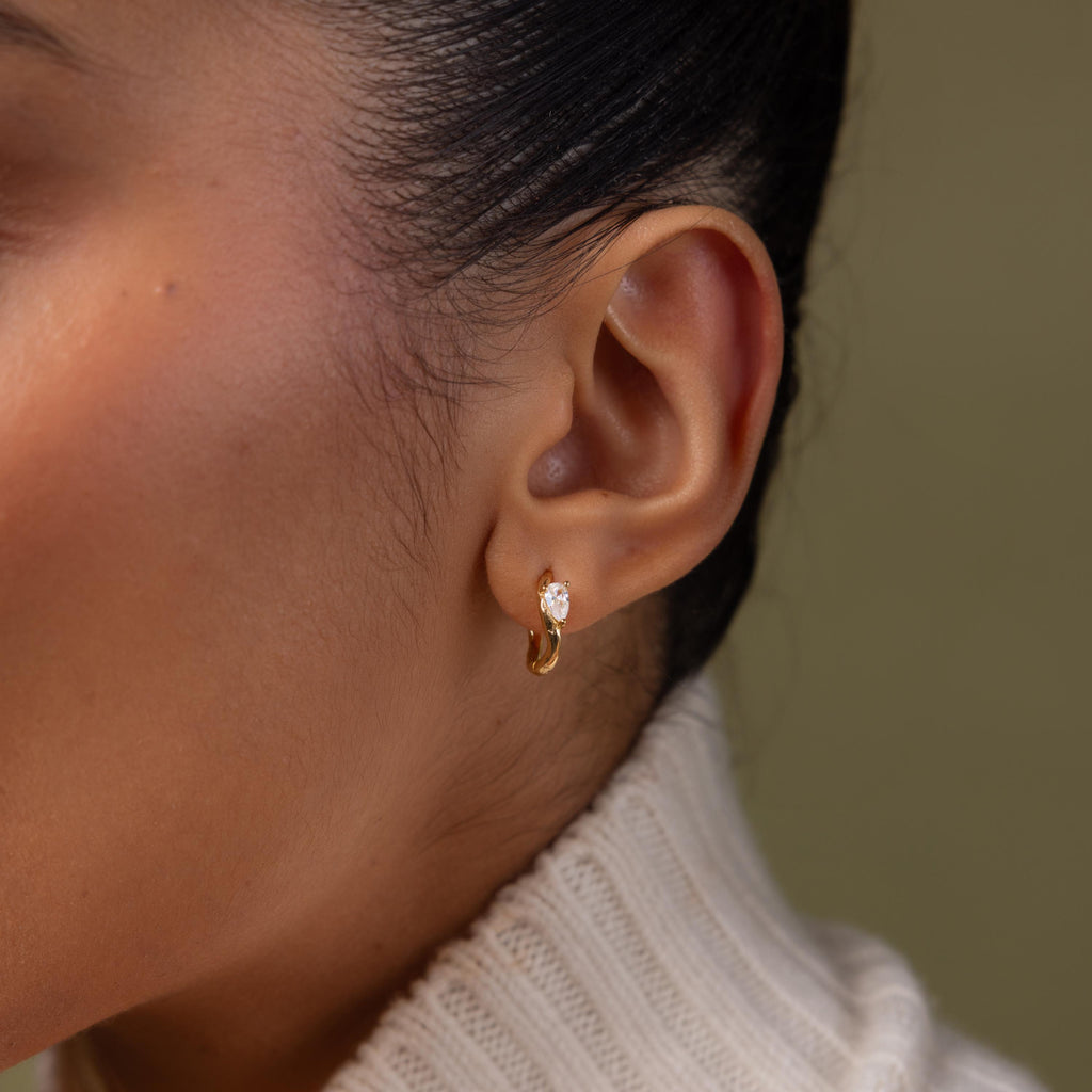 Close up of model wearing our Hammered Diamond Teardrop Hoops in Gold
