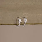 Flatlay of our Hammered Diamond Teardrop Hoops in Silver