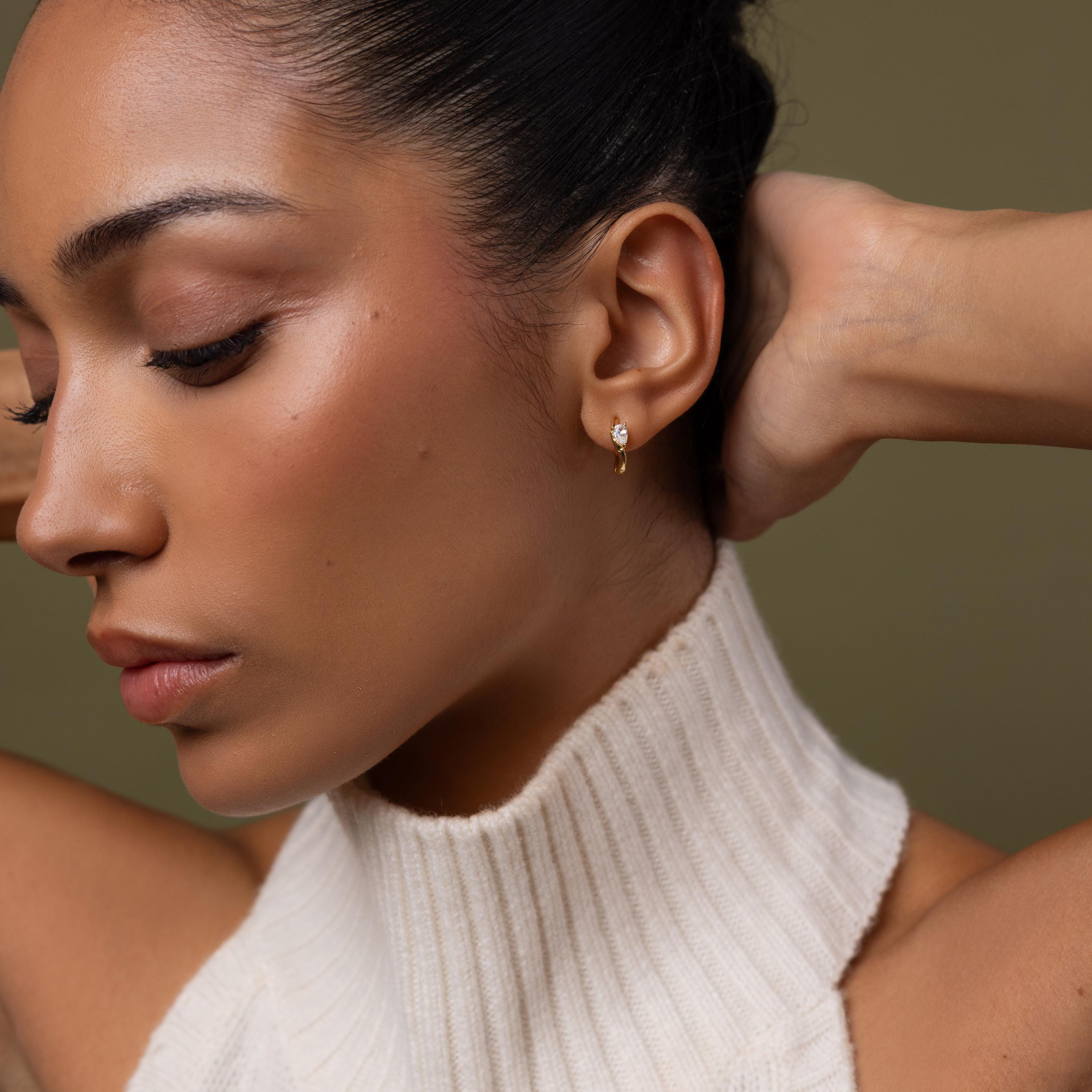 Model wearing our Hammered Diamond Teardrop Hoops in Gold