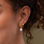 Close up of model wearing our Bubble Initial Flatback Studs, styled with our Initial Pearl Earrings and Pearl Studs