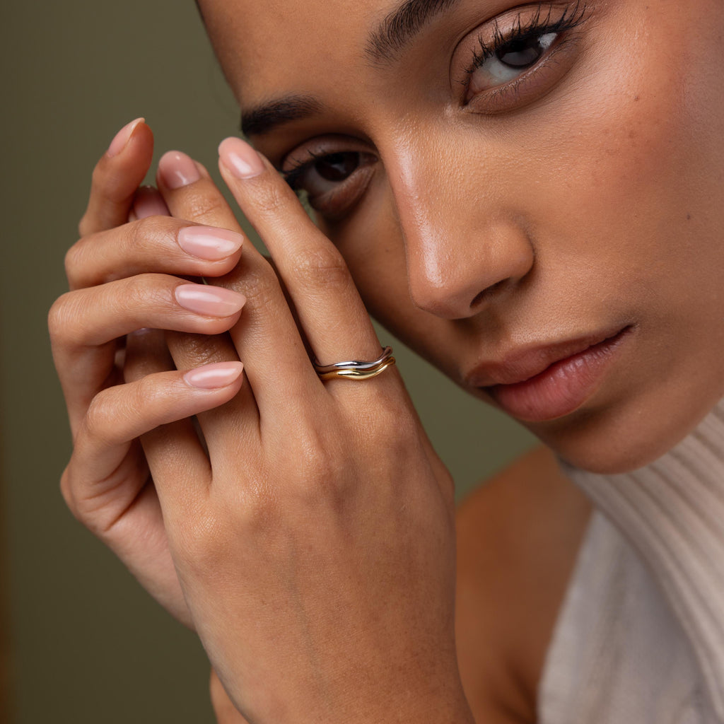 Close-up of a model wearing our Mixed Metal Wave Ring Set