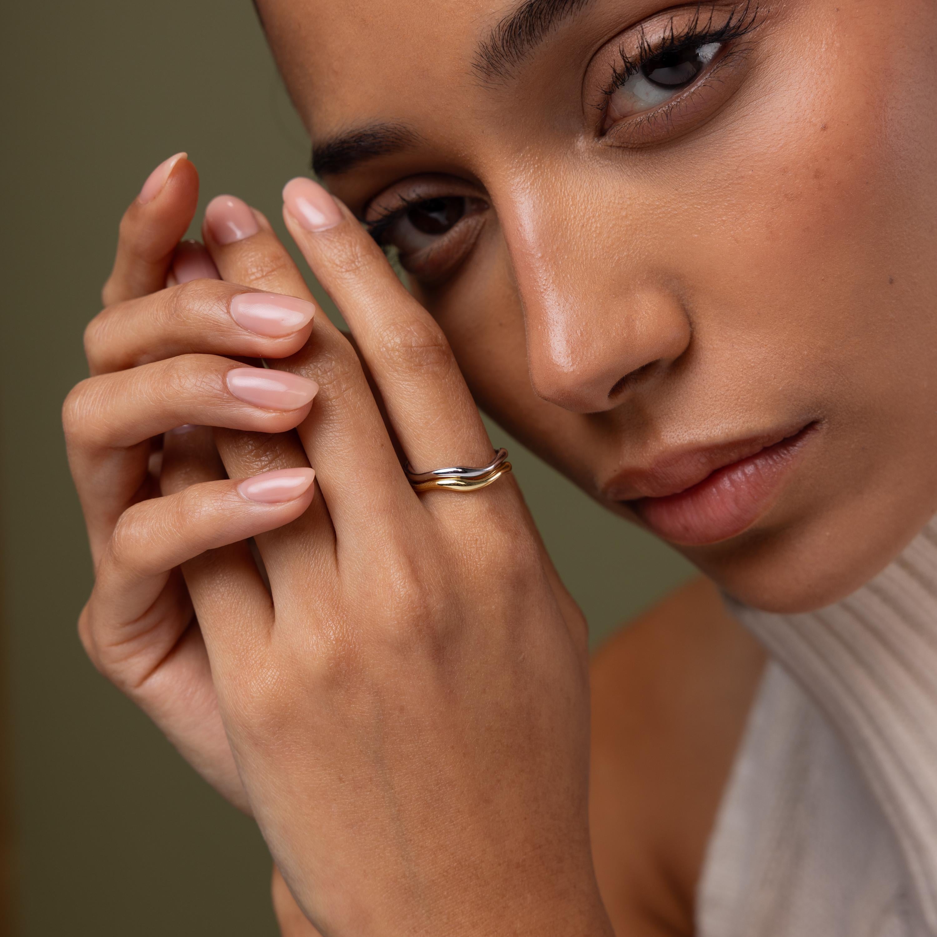 Close-up of a model wearing our Mixed Metal Wave Ring Set