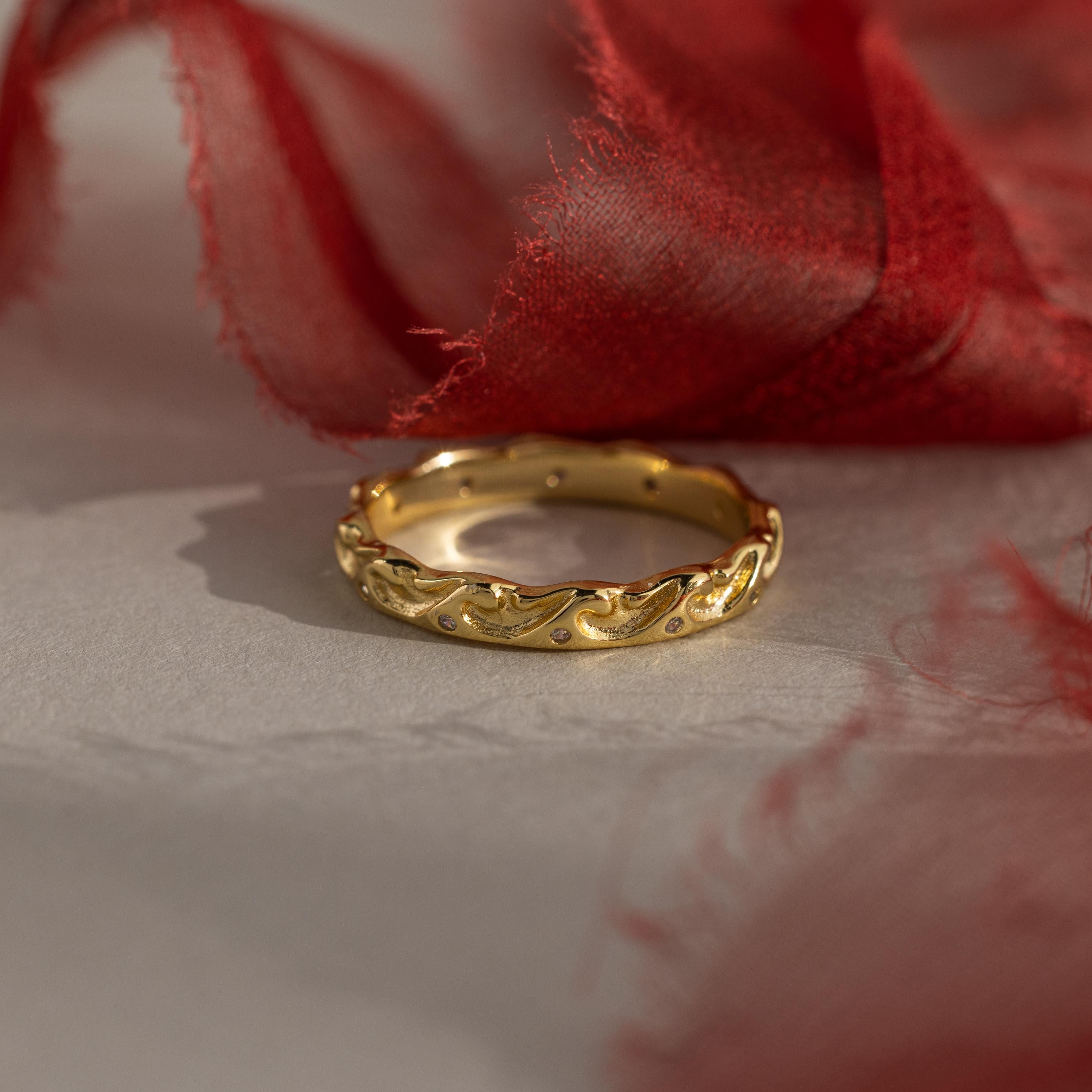 Flatlay of our Diamond Wave Band against red ribbons