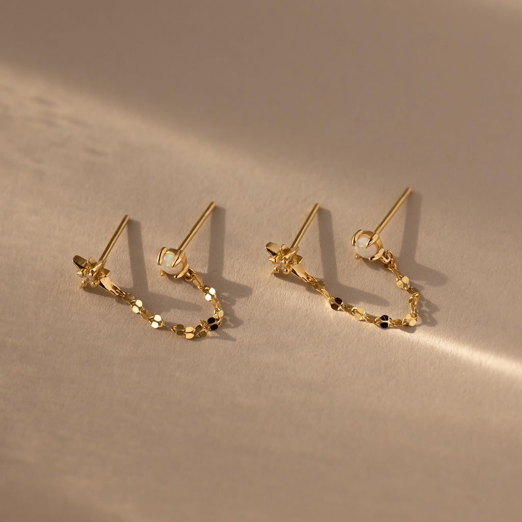 Flatlay of our Opal & Star Duo Chain Studs in Gold
