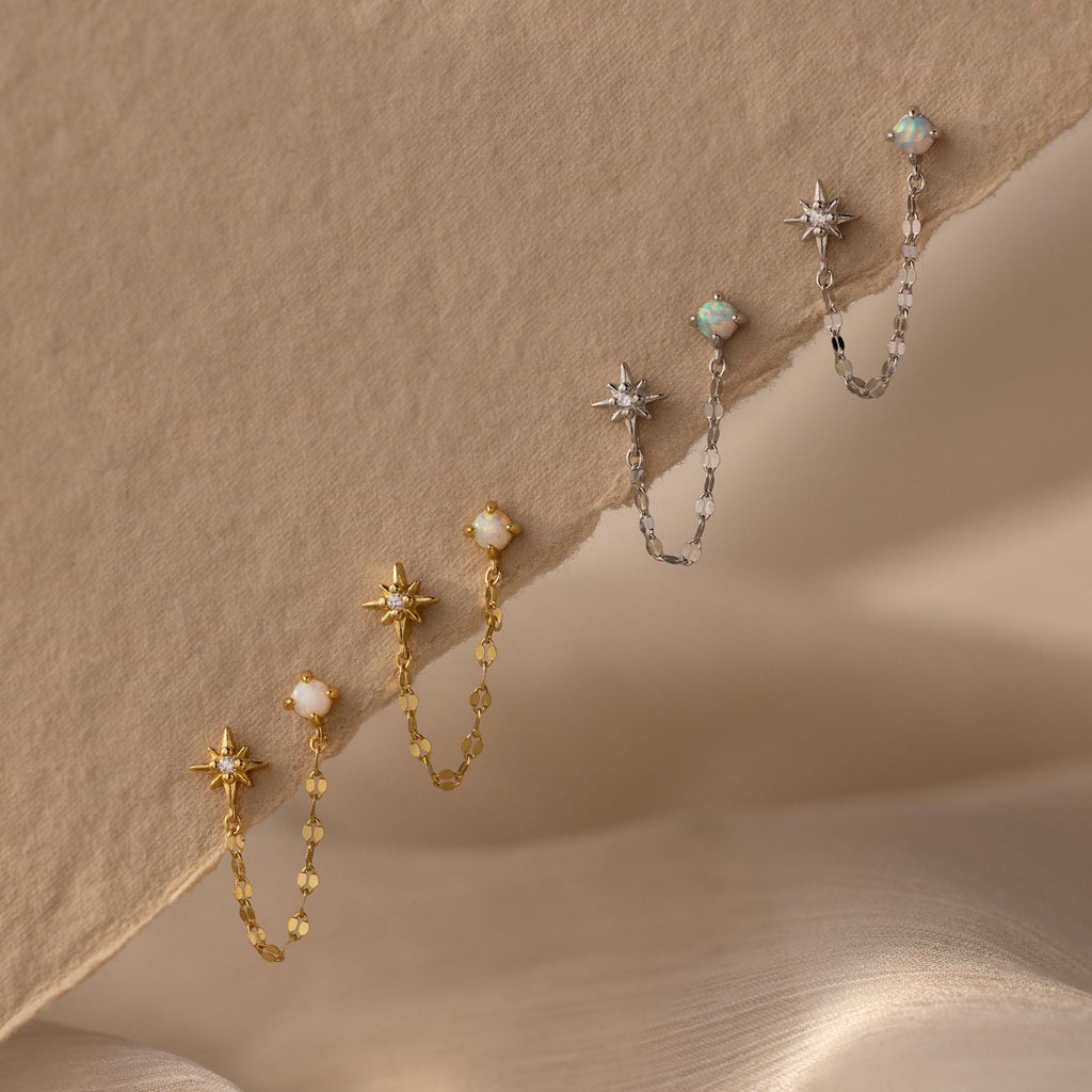 Flatlay of 2 pairs of our Opal & Star Duo Chain Studs in Silver and Gold