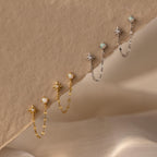 Flatlay of 2 pairs of our Opal & Star Duo Chain Studs in Silver and Gold