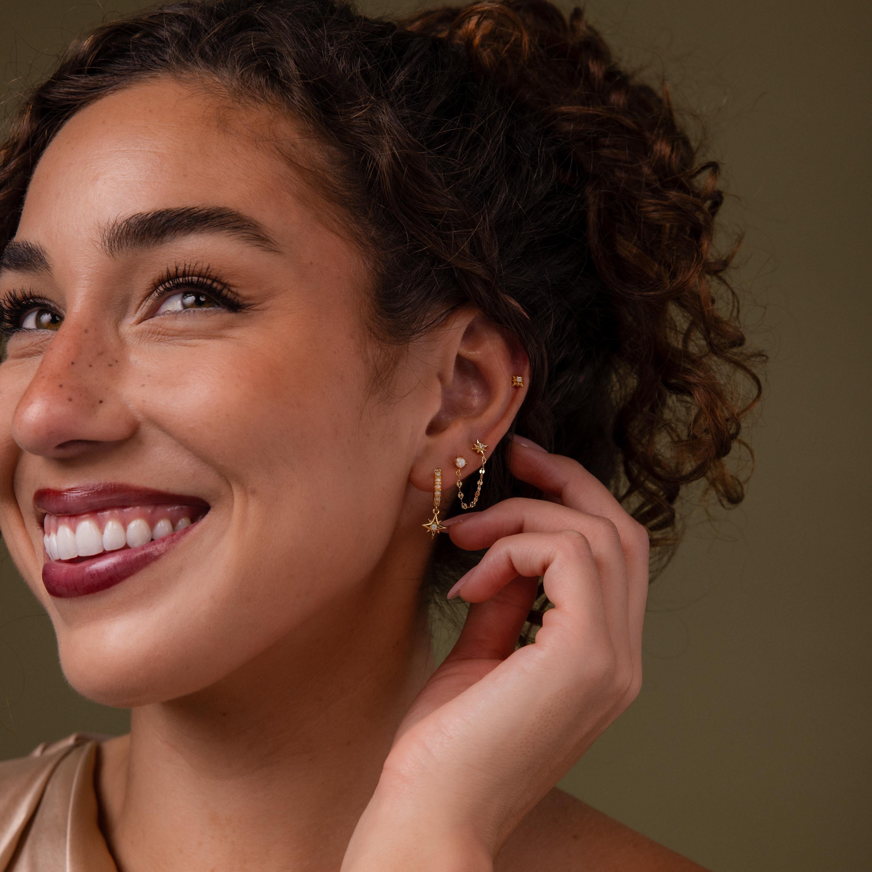 Model wearing our Opal & Star Duo Chain Studs, styled with our North Star Flatback Studs and Pave Opal Star Huggies