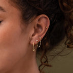 Close-up of a model wearing our Opal & Star Duo Chain Studs, styled with our North Star Flatback Studs and Pave Opal Star Huggies