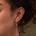 Close up of model wearing our Opal & Star Duo Chain Studs, styled with our Northstar Flatback Studs and Pave Opal Star Huggies