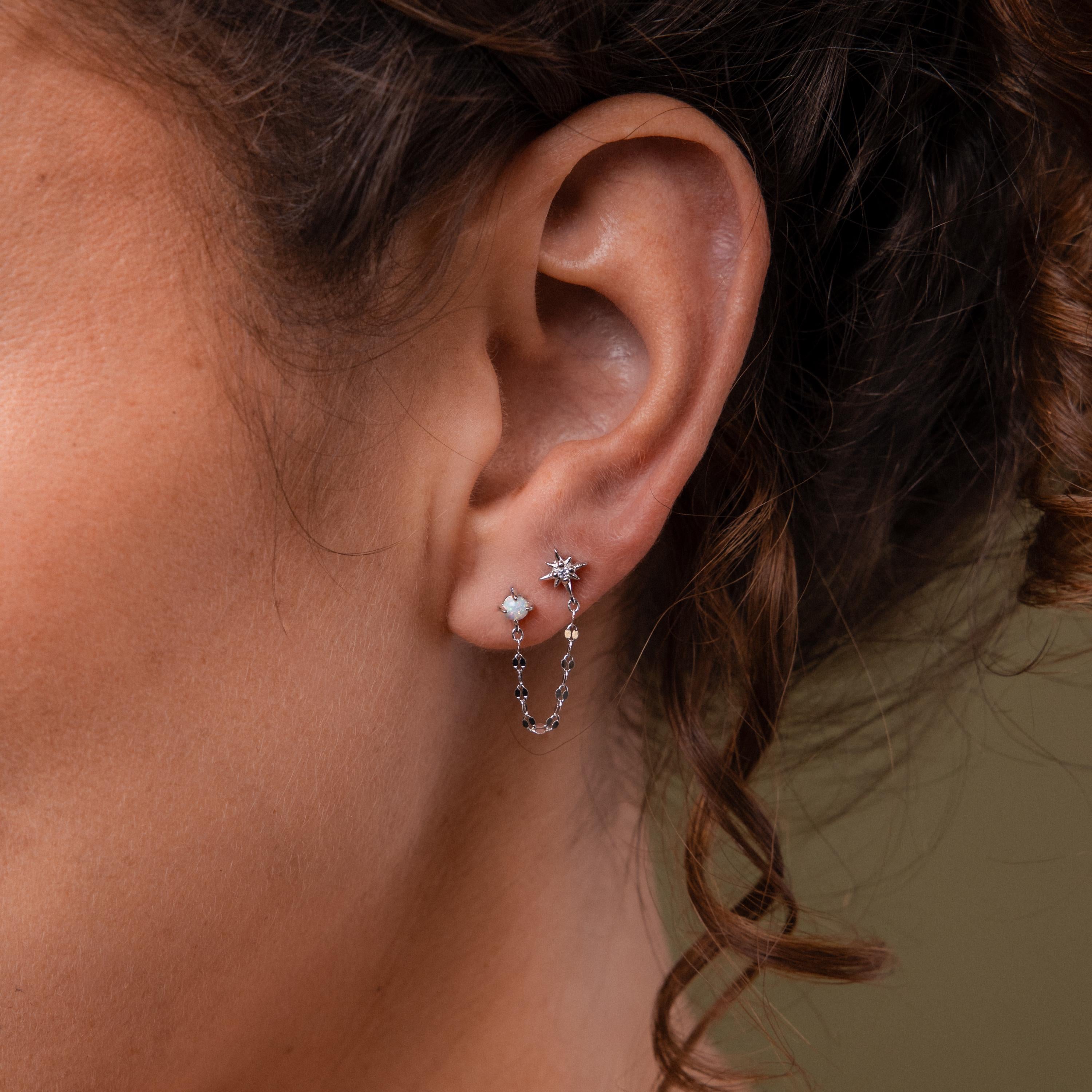 Close-up of a model wearing our Opal & Star Duo Chain Studs