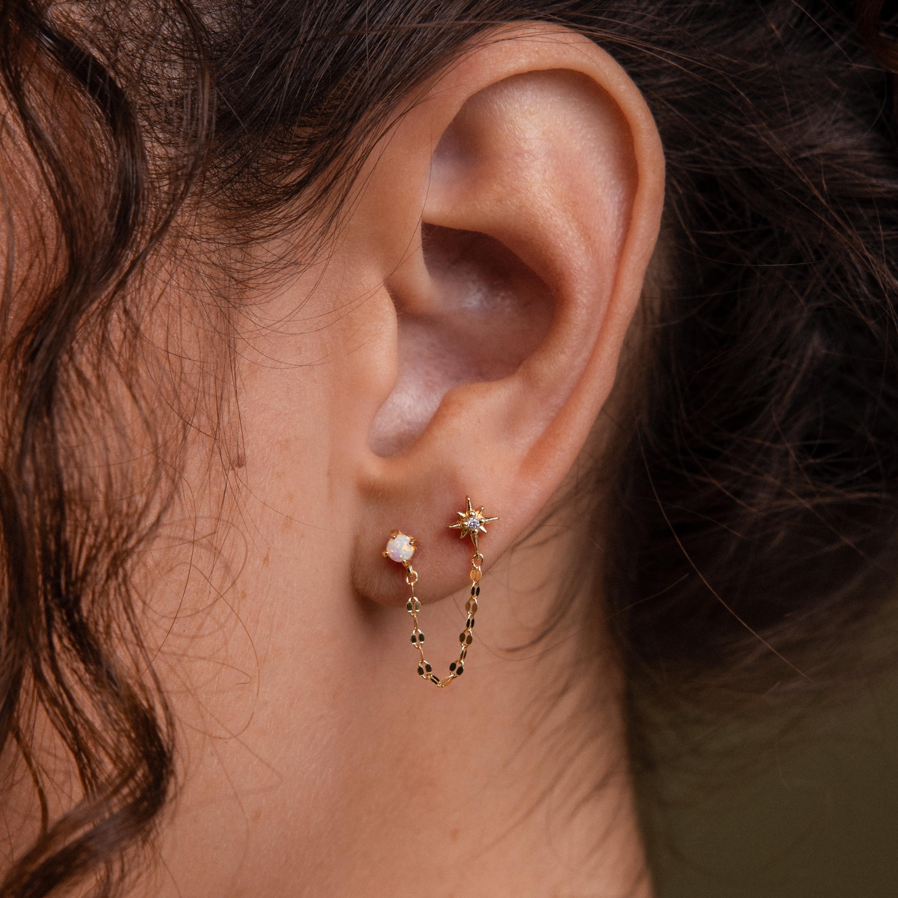 Close-up of a model wearing our Opal & Star Duo Chain Studs