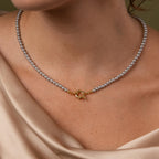 Close up of model wearing our Smoky Pearl Clasp Necklace