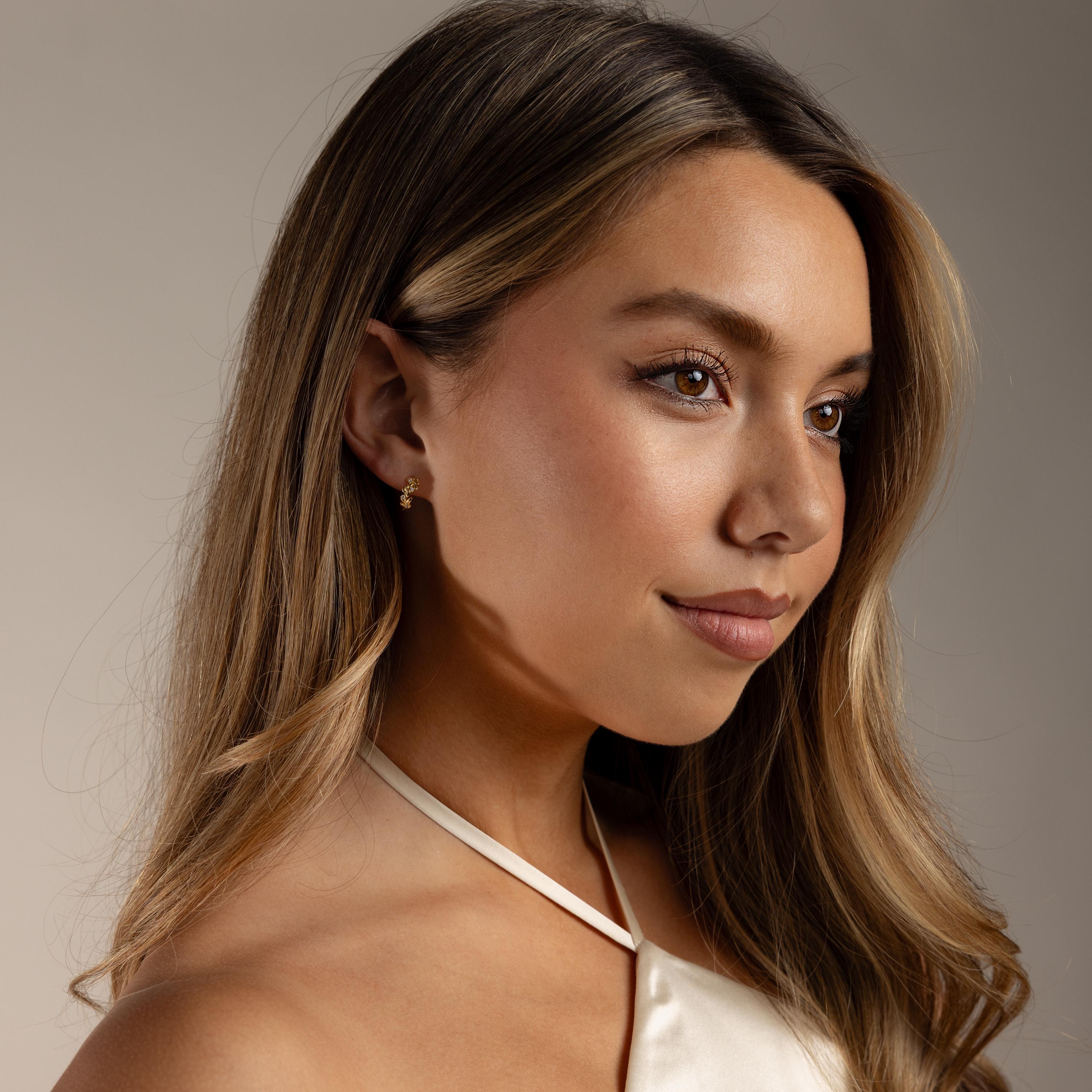 Faraway photo of a model wearing our Diamond Leaf Hoops in Gold