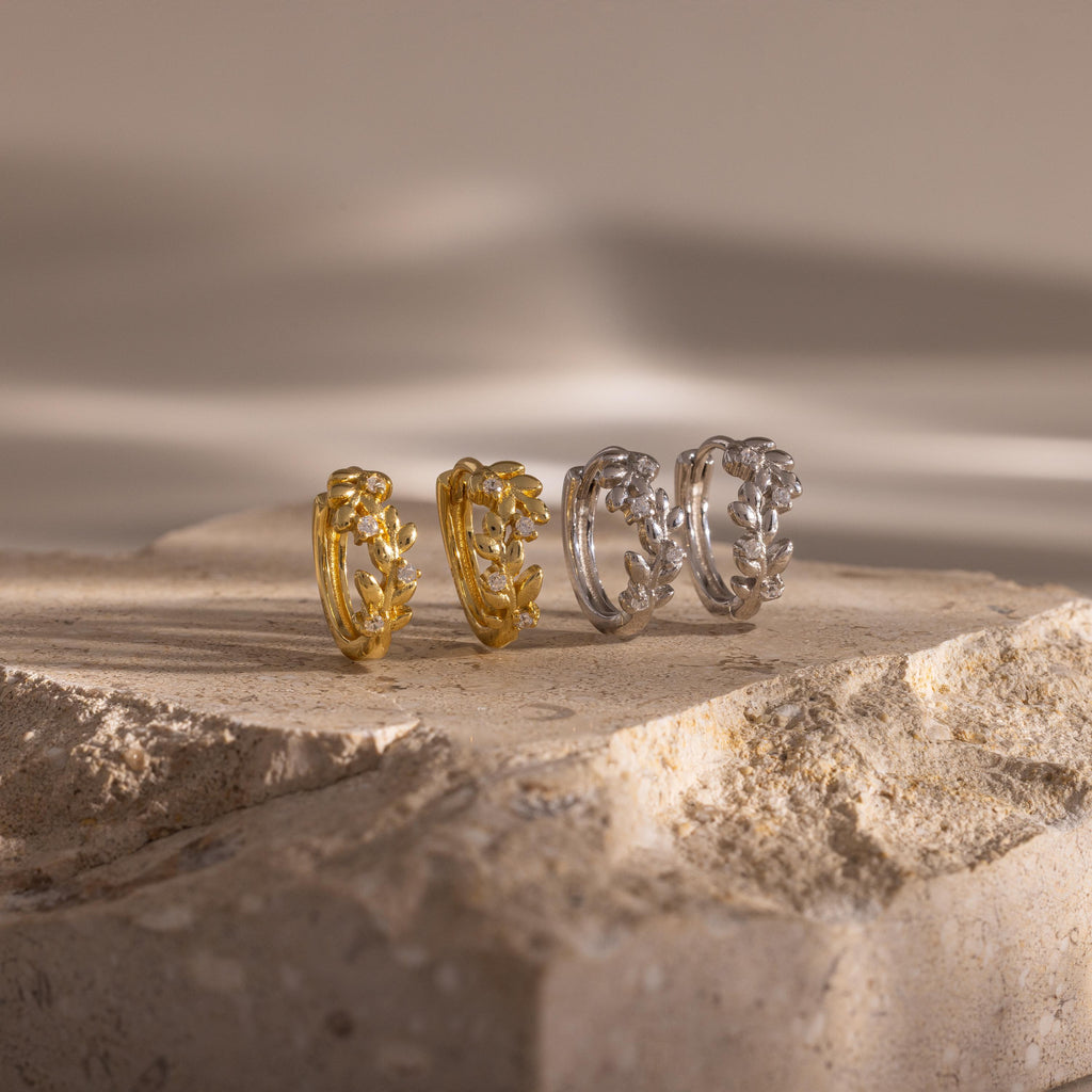 Close up image of 2 pairs of our Diamond Leaf Hoops in Gold and Silver